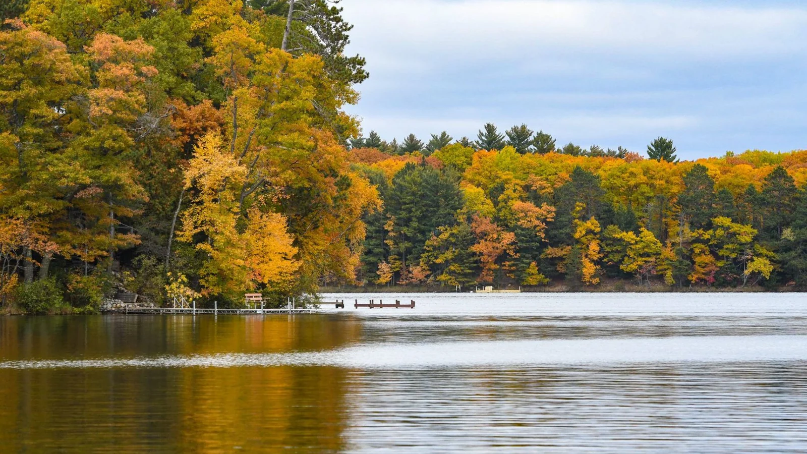 A calm Northwoods lake ringed with autumn colour