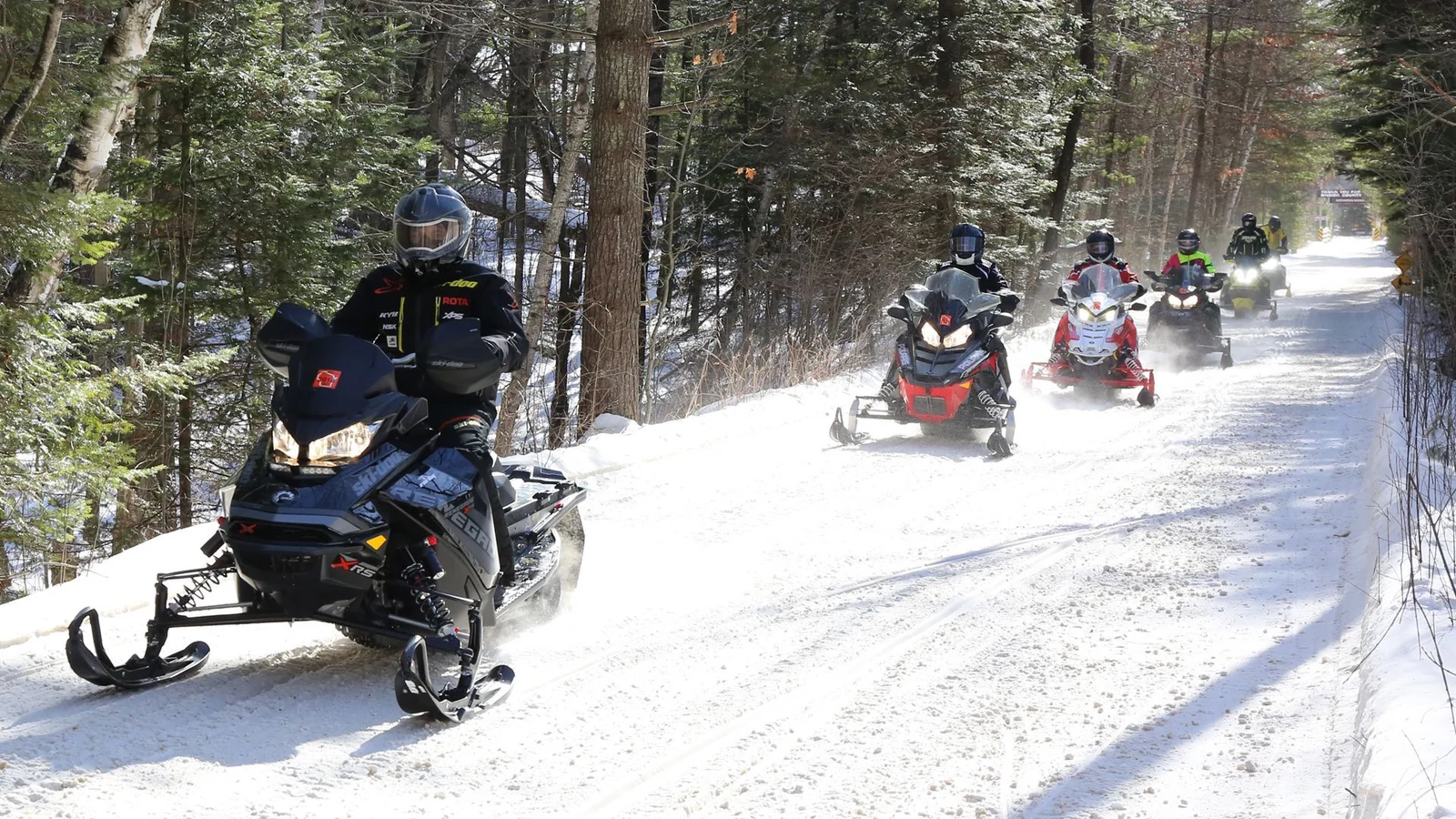 Snowmobiles on a groomed winter trail