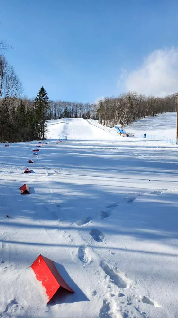 Groomed snow under a bright winter sky